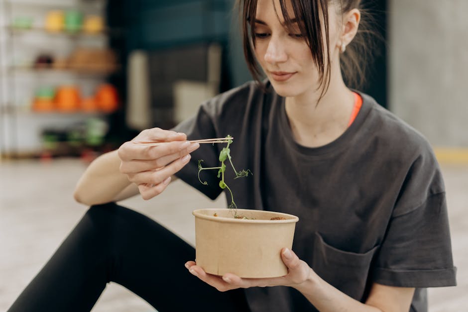 Young woman enjoying a healthy salad indoors, focusing on balanced nutrition and healthy living