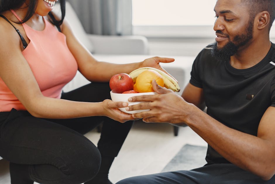A happy couple enjoying fresh fruits together at home, promoting a healthy lifestyle