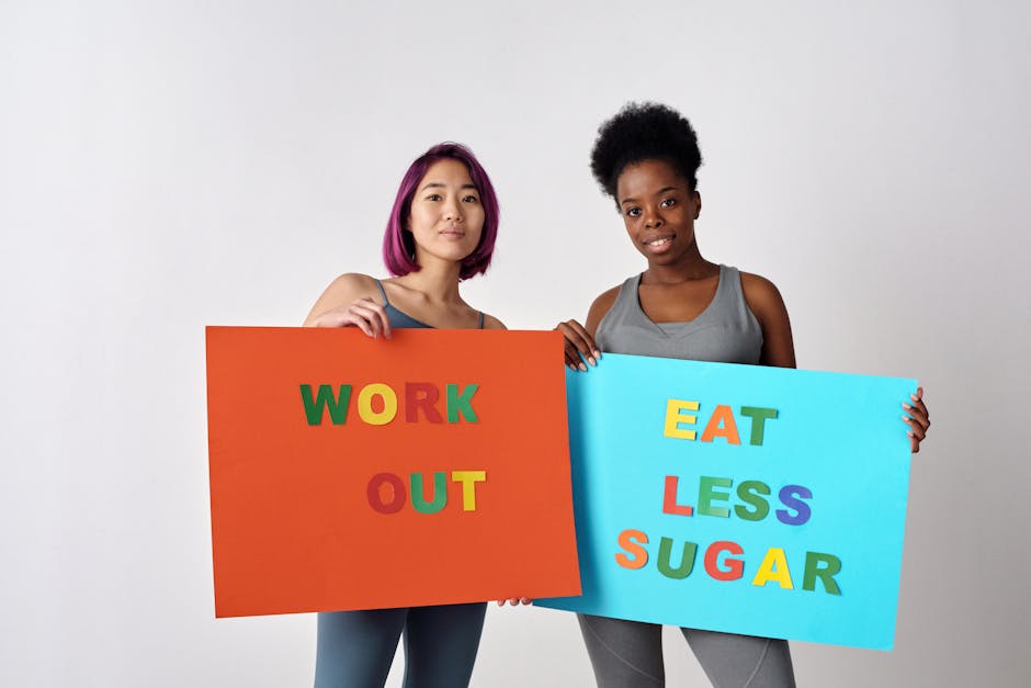 Two women holding motivational posters promoting healthy lifestyle changes against a white background